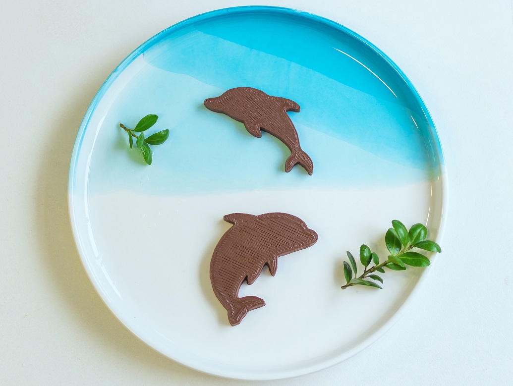 Two little dolphins are swimming happily in your dish.